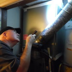 During home inspections, Ron Lane checks water heater components