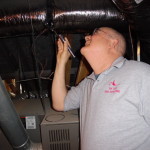 Ron Lane performs insulation checks during home inspections